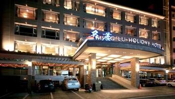 Vista frontal de la propiedad por la tarde o noche