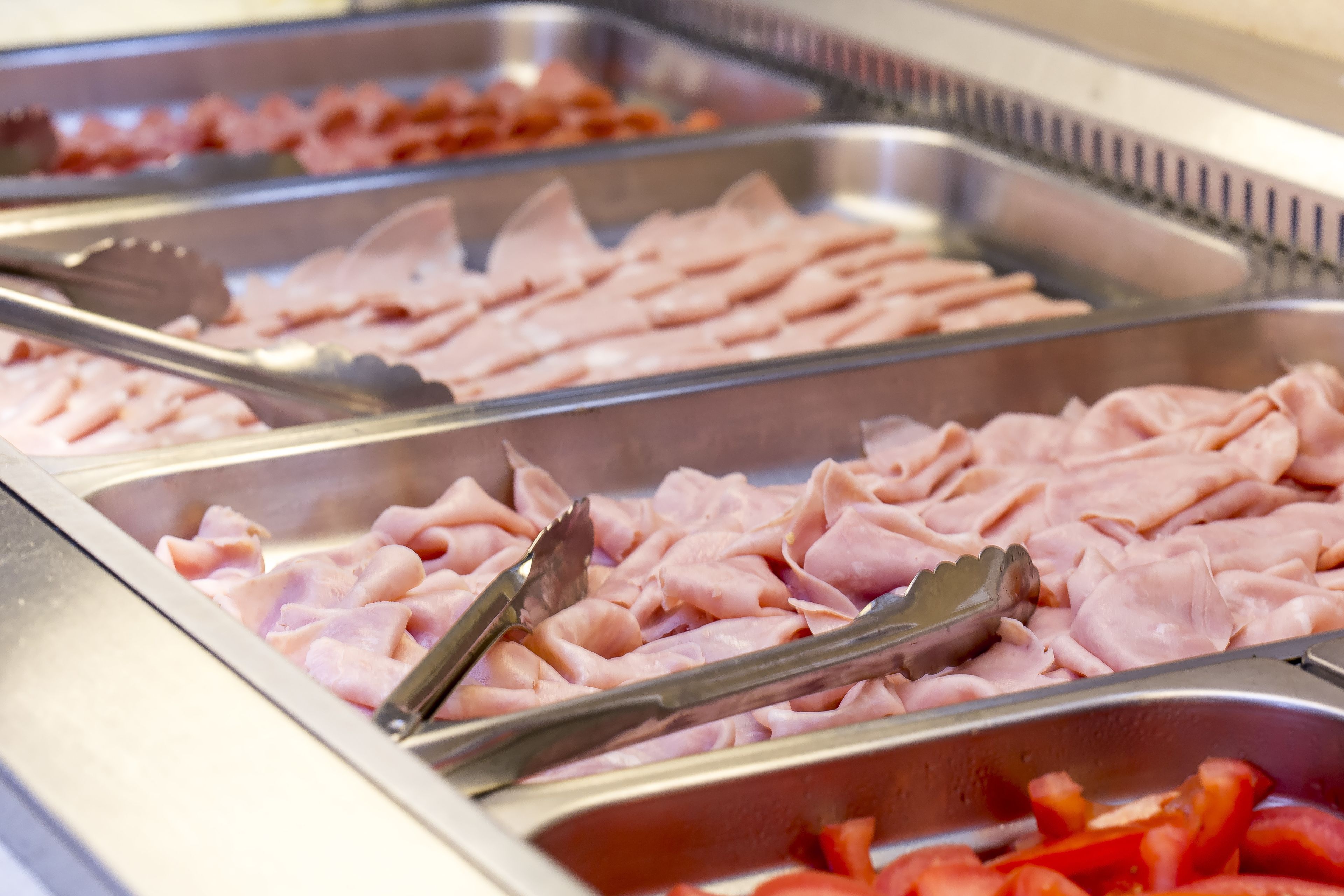 A buffet with various meats and vegetables.