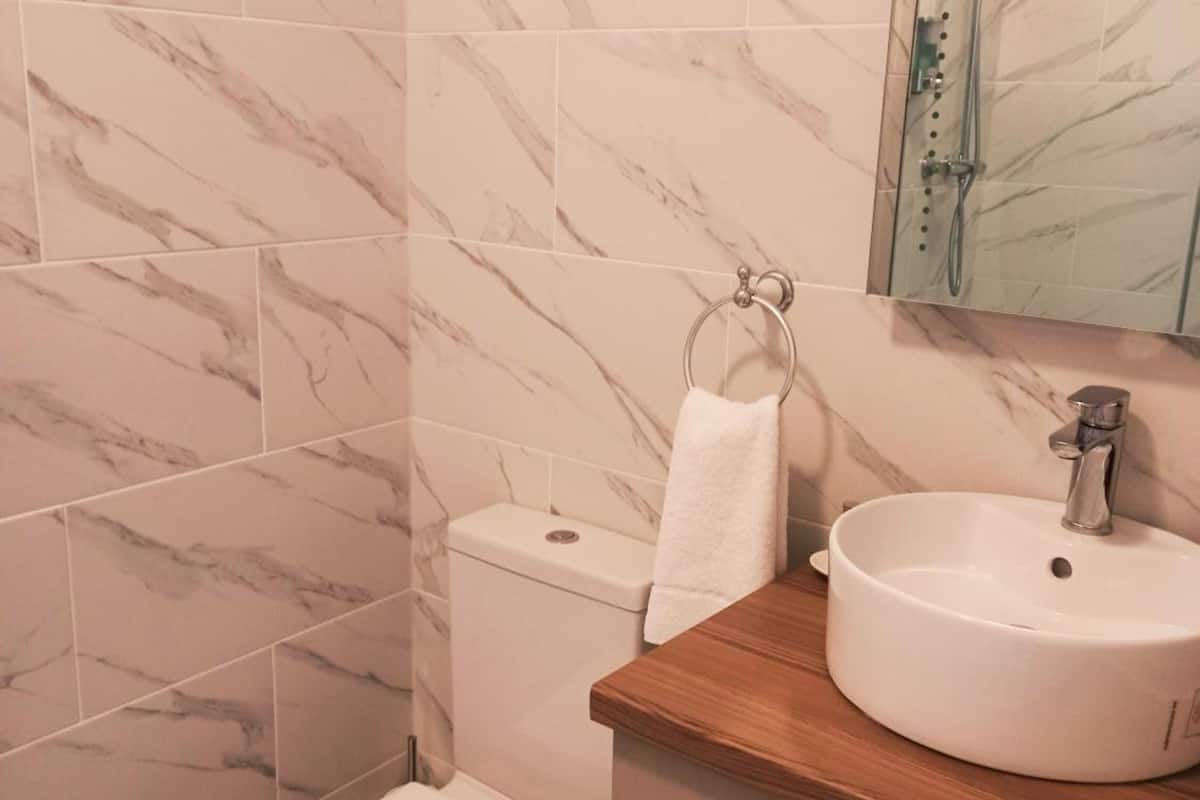 standard double room | bathroom | shower, hair dryer, towels, soap