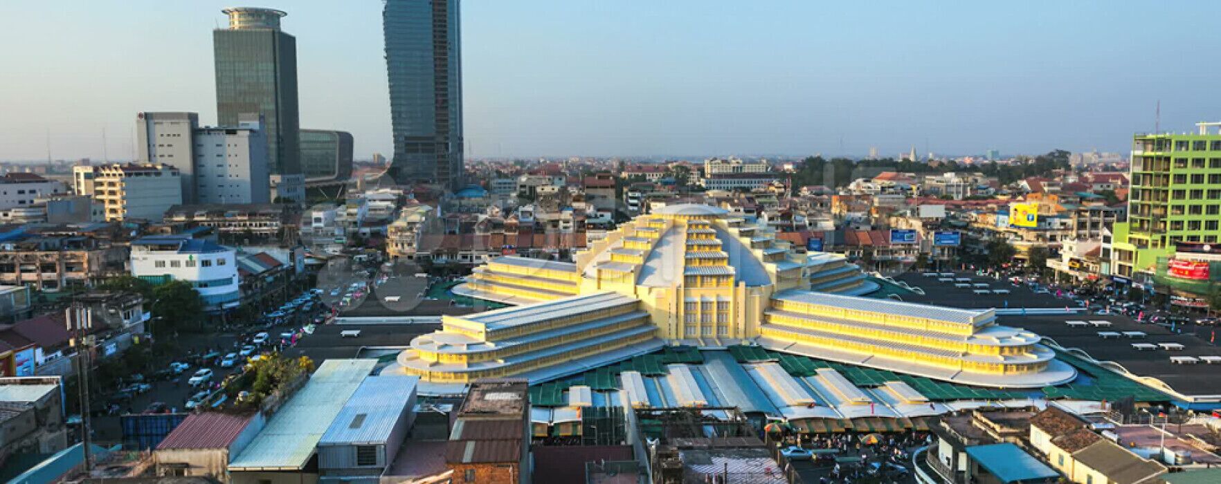 A large, multi-story building with a central courtyard and surrounding structures.