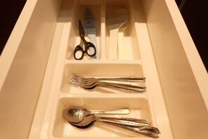 A drawer with neatly arranged cutlery including forks, a spoon, and scissors. - 2BR Apartment with City View @ Woodland Park Residence (Jakarta)