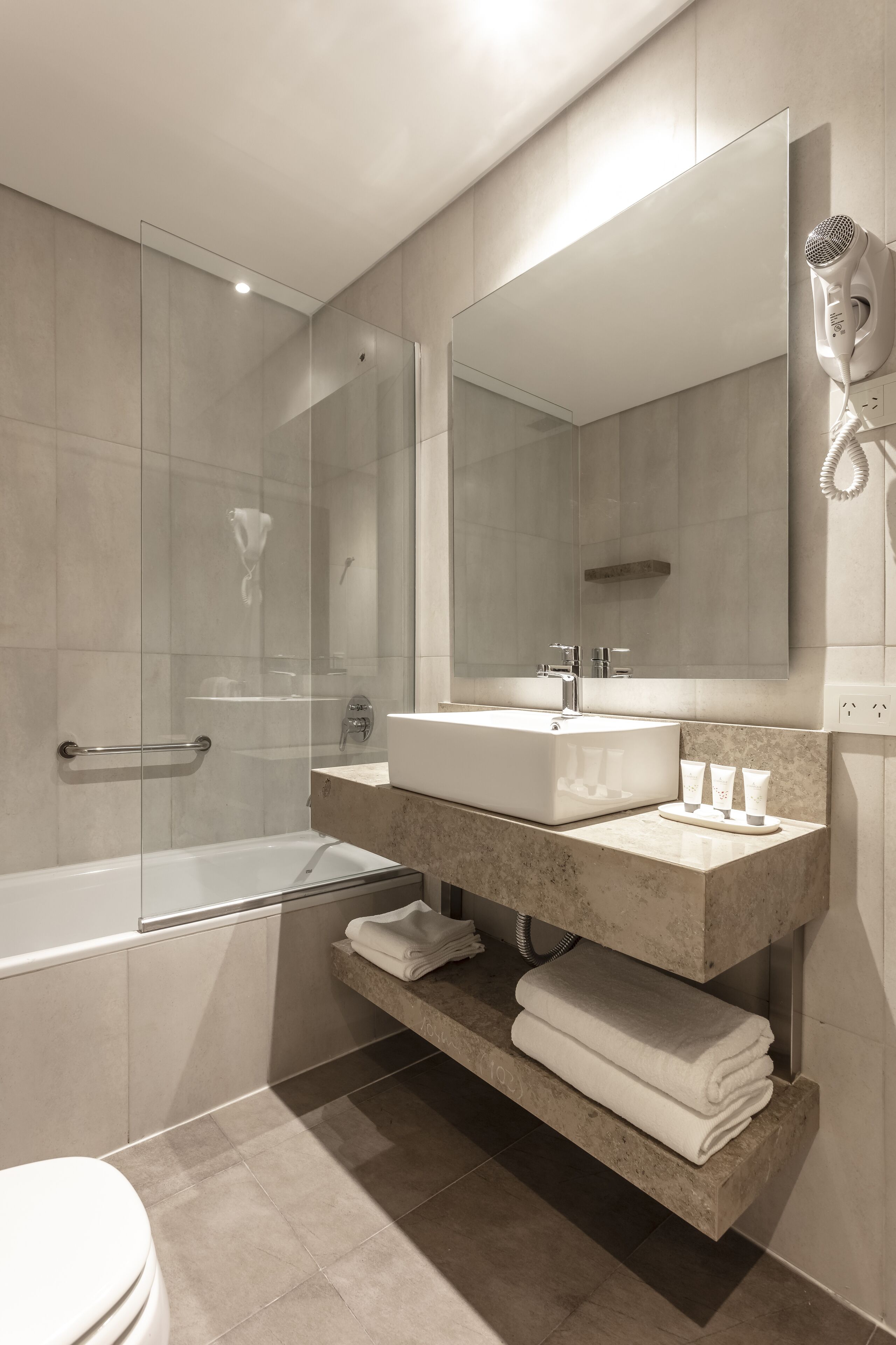 deep-soaking bathtub, rainfall showerhead, hair dryer, bidet