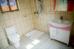 Designer toiletries, hair dryer, slippers, towels