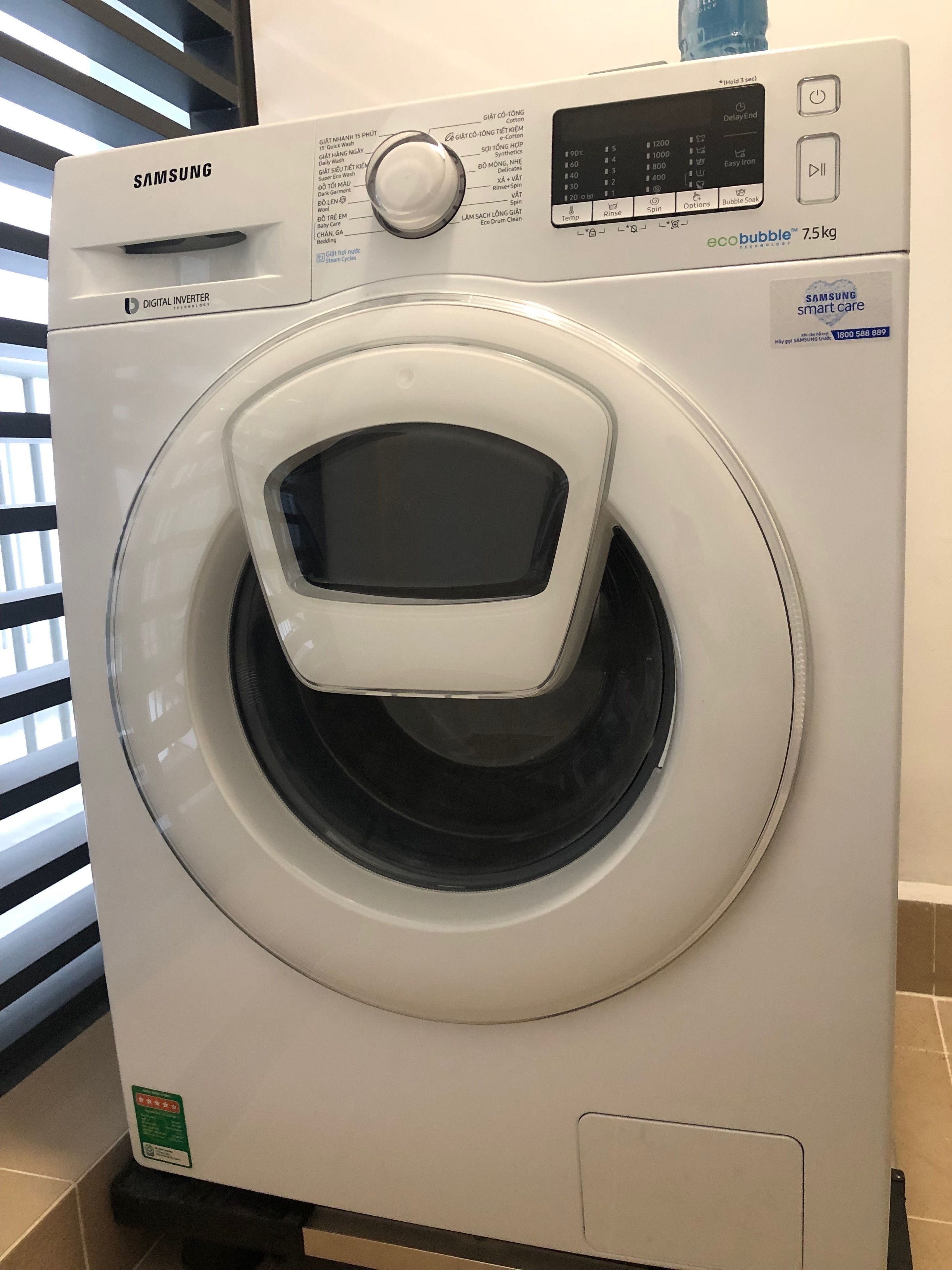 A Samsung digital inverter washing machine with a control panel, a digital display, and a water level indicator.