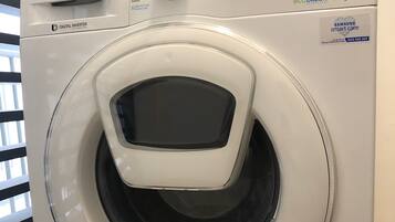 A Samsung digital inverter washing machine with a control panel, a digital display, and a water level indicator.