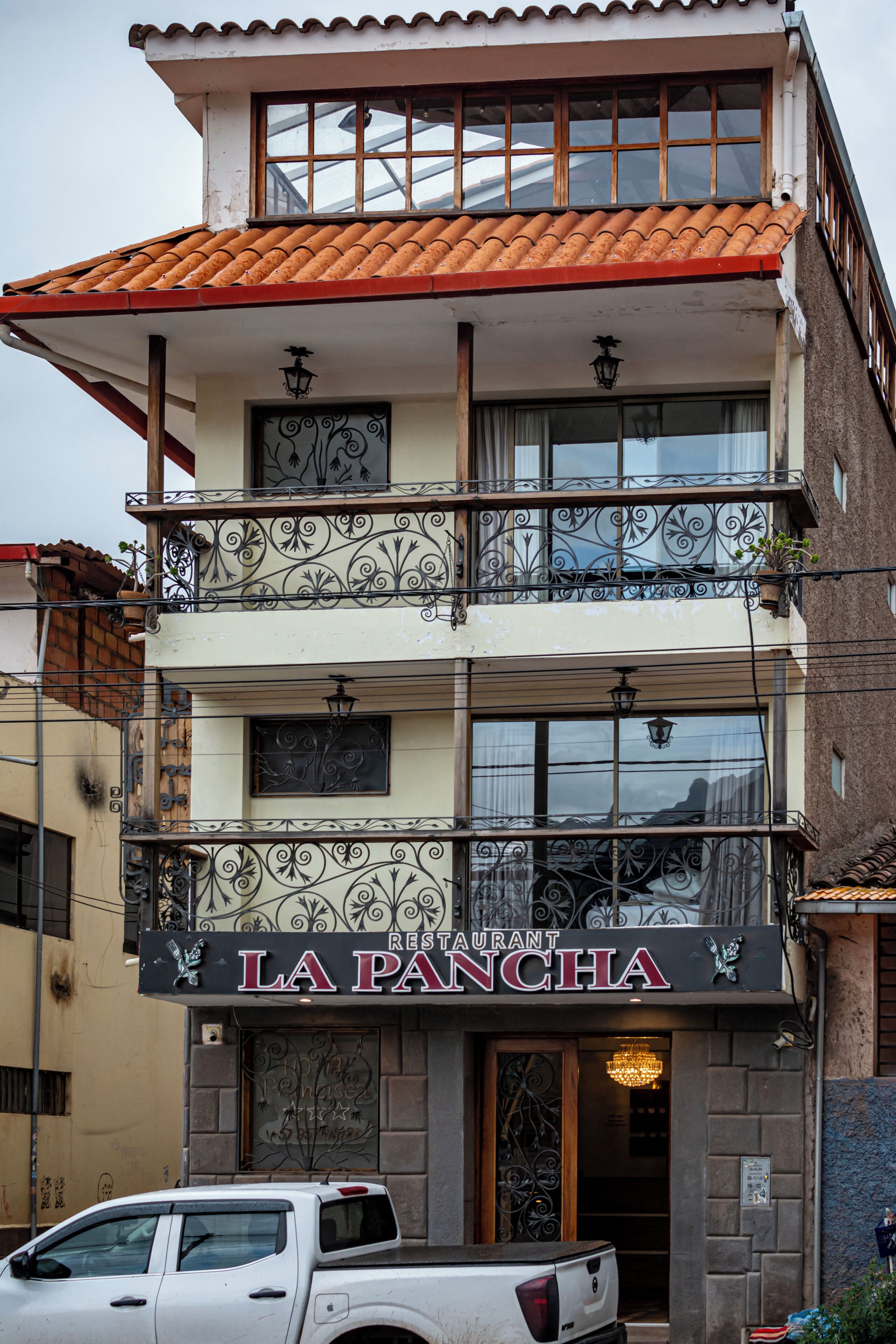 A multi-story building with a restaurant named 'LA PANCHA' on the ground floor.