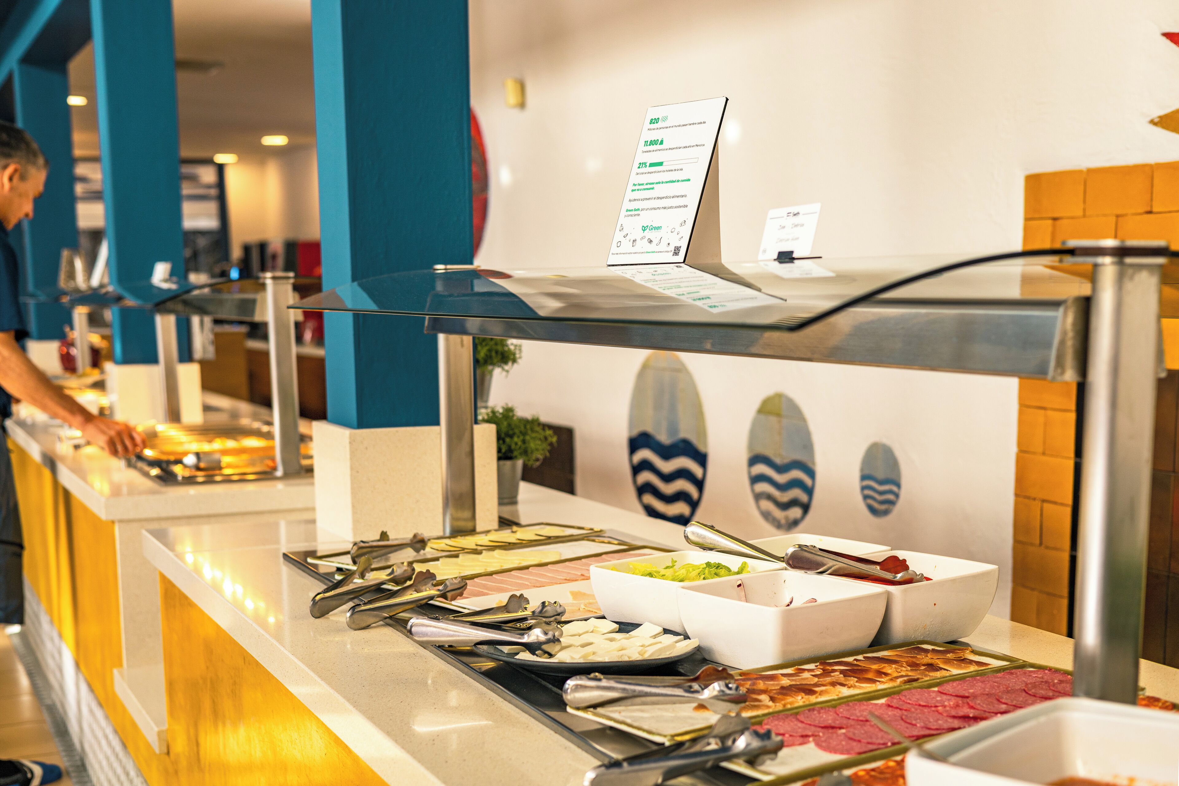 A buffet with various food items and utensils.