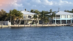 A beachfront property with two houses, palm trees, and a dock. - 2 Incredible Waterfront Homes - One Low Price! (Marathon)