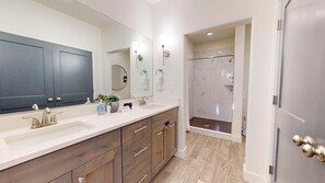 Bathtub, hair dryer, towels, shampoo