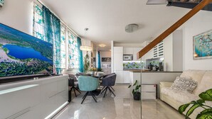 A modern kitchen with white cabinets, a built-in microwave, and a coffee machine. - Cozy apartment in Zadar with WiFi (Zadar)