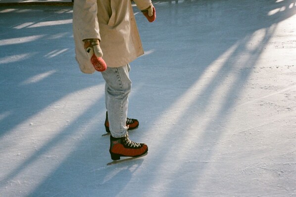 A person ice skating on a smooth, flat surface.