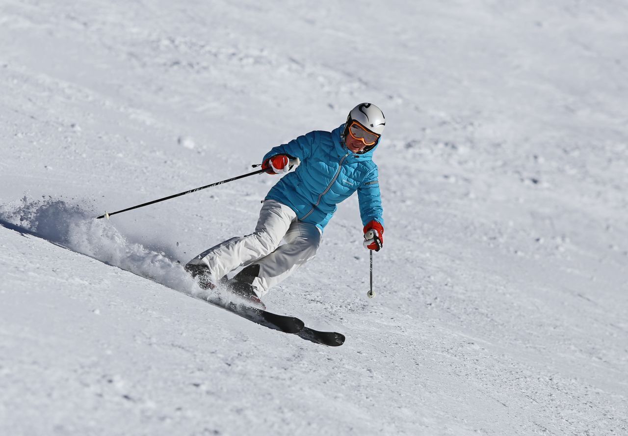 A person skiing down a snowy slope.