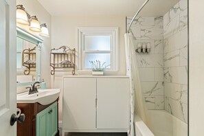 Combined shower/tub, hair dryer, towels, soap