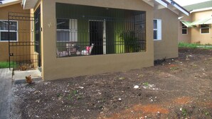 A residential building with a large window and a gated entrance. - A single family home in a secure gated community where you can feel at home (Florence Hall Village)