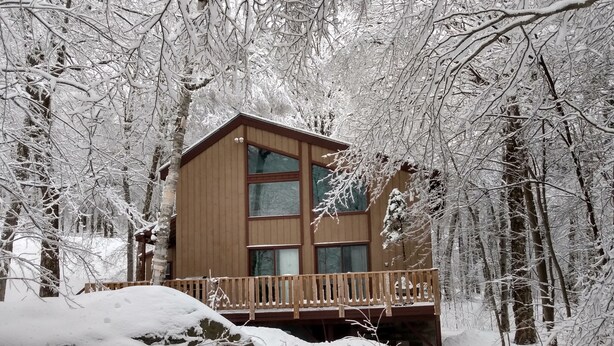 A wooden cabin with a balcony, surrounded by snow-covered trees. - Chimney Hill Mtn Chalet w/resort access - heated pools, trails, near lake & town (Wilmington)