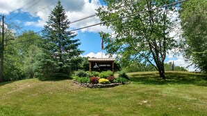 A lodge named Chimney Hill surrounded by lush greenery and a clear sky. - Chimney Hill Mtn Chalet w/resort access - heated pools, trails, near lake & town (Wilmington)