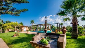 A backyard with a barbecue grill, a small pool, and a gazebo. - Finca in Mallorca Can Caragol Inca with pool (Inca)