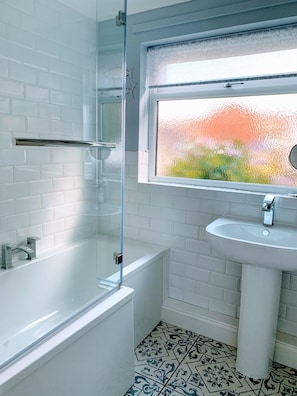 Combined shower/tub, hair dryer, towels, soap