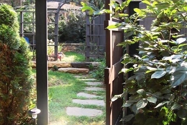 A stone path winding through the Studio's garden leads to its private entrance.