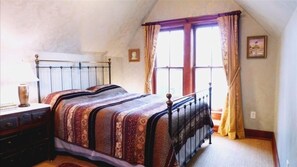 Classic bedroom with a single bed, nightstand, and framed picture.