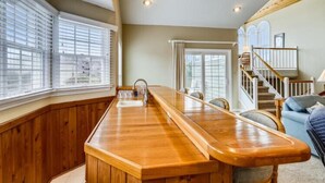 A kitchen with a wooden countertop, a sink, and a window with blinds. - Semi OF - CHEVEN at Ships Watch In Duck (Duck)
