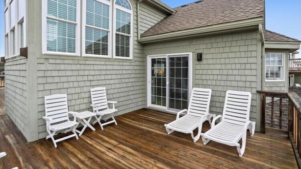 A house with a deck, white outdoor furniture, and a large sliding glass door. - Semi OF - CHEVEN at Ships Watch In Duck (Duck)