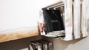 A rustic wall shelf with a 'PALIO' book and various items. - THE CASINA OF SANT 'AGOSTINO (Colle di Val d'Elsa)