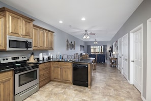 Enjoy cooking in this well-equipped kitchen with a central island, oven, microwave, and dishwasher.