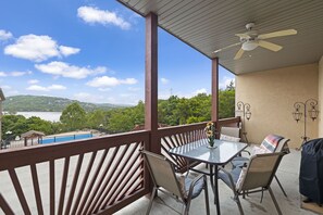 Enjoy a serene lake view from the balcony, perfect for dining or socializing with a table and chairs.