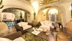 A luxurious interior with a pool, comfortable seating, and a dining area. - ANTICO POSITANO - Five Bedroom Villa, Sleeps 9 (Positano)