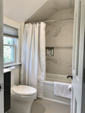 Bathtub, hair dryer, towels, soap