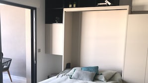 A bedroom with a bed, a chair, and a wardrobe. - New! Luxury apartment in Pietrosella at 300 m from the beach (Pietrosella)