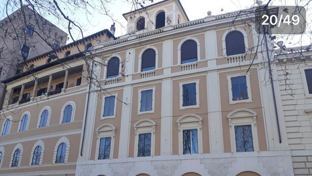 A multi-story building with a classical architectural style, featuring arched windows and a central balcony. - View of Castel Sant'Angelo (Roma)