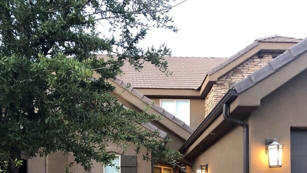 A two-story house with a stone facade, a gated entrance, and a landscaped front yard. - Your home away from home! (Washington)