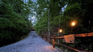 A gravel path leading to a wooden gate with a sign reading "Solitude." - Secluded Blue Ridge Cabin, Hot Tub/Mountain Views/Fire Pit/Family Game Rm (Blue Ridge)