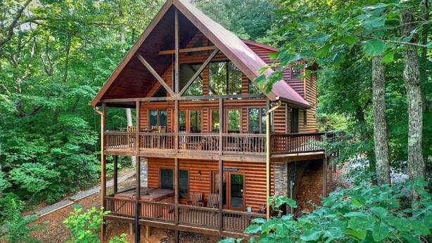 A multi-story log cabin with a balcony on each floor, surrounded by dense forest. - Secluded Blue Ridge Cabin, Hot Tub/Mountain Views/Fire Pit/Family Game Rm (Blue Ridge)