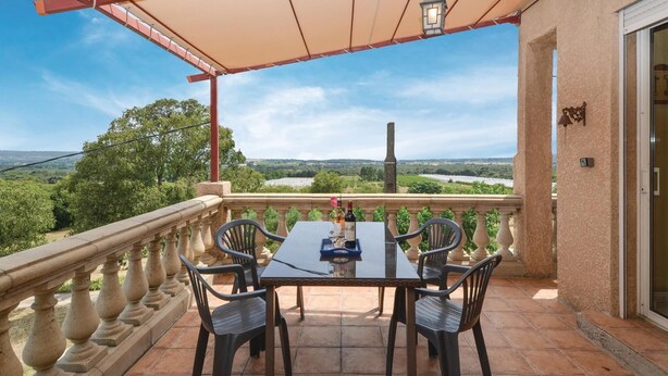 A terrace with a table and chairs, a view of the countryside, and a lamp post. - Stunning home in Montaren et St Mediers (Montaren et St Mediers)