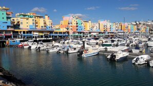 A marina with colorful buildings and boats docked. - Country house with exclusive pool (Paderne)