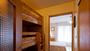 A room with bunk beds, a wooden door, and a view of another room with a bed and a window. - Studio for 5, Central, South Balcony, Elevator - Brides-les-Bains (Brides-les-Bains)
