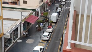 Experience the vibrant energy of the city's commercial district, surrounded by shops and businesses.