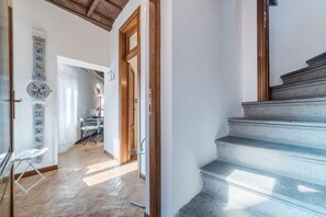A staircase leading to a second floor, a wooden door, and a herringbone-patterned floor. - Great apartment - Navona area (Roma)