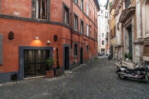 A narrow cobblestone street with buildings on either side.