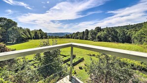 A balcony with a view of a green field and forested hills. - Lovely Brookfield Home w/ Private Deck & Views (Brookfield)