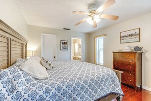 A bedroom with a bed, a wooden dresser, a ceiling fan, and a framed picture on the wall. - Pet-Friendly Home w/ Pool, Close to Venice Beaches (Venice)