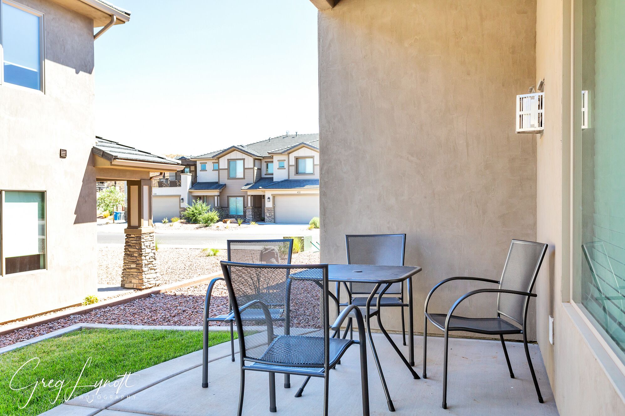 A patio area with outdoor seating and a view of neighboring buildings.