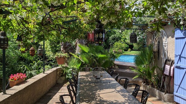 A covered outdoor seating area with a pool in the background. - Almond room with whirlpool bath (Plan-de-la-Tour)