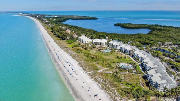 An aerial view of a coastal hotel with a long beachfront, multiple buildings, and a swimming pool. - Captiva Beach Villas 🏝 On The Gulf Beach (Captiva)