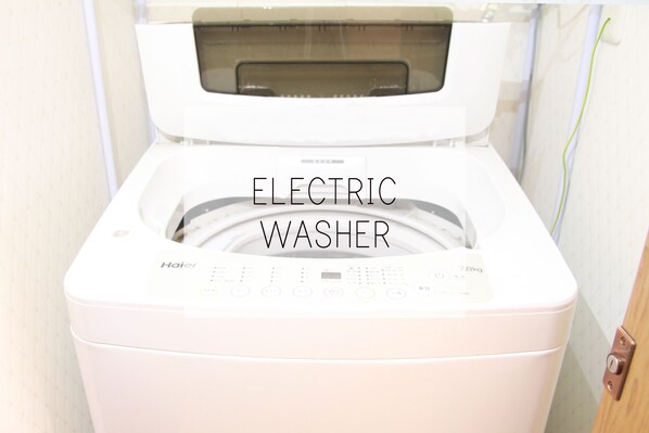 Une machine à laver électrique dotée d’un panneau de commande et d’une étiquette indiquant une capacité de 7 kg.