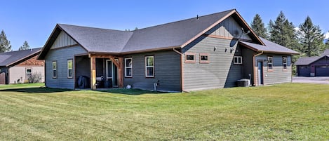 A two-story house with a sloped roof, a covered front porch, and a well-maintained lawn.
