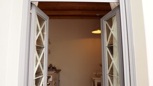 An open doorway with a wooden ceiling and a hanging light fixture.